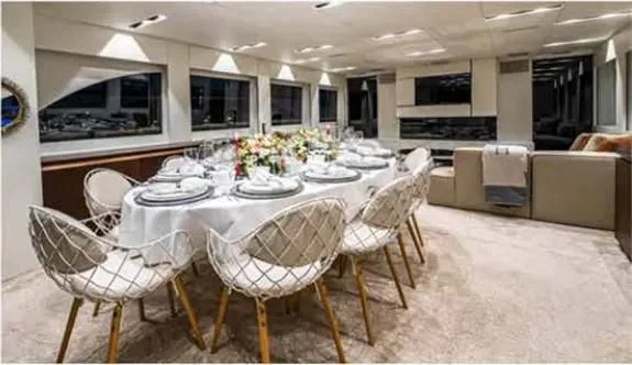 a large dining room with white tables aboard HARUN Yacht for Charter