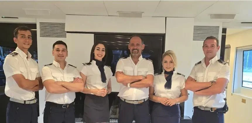 a group of people posing for a photo aboard HARUN Yacht for Charter