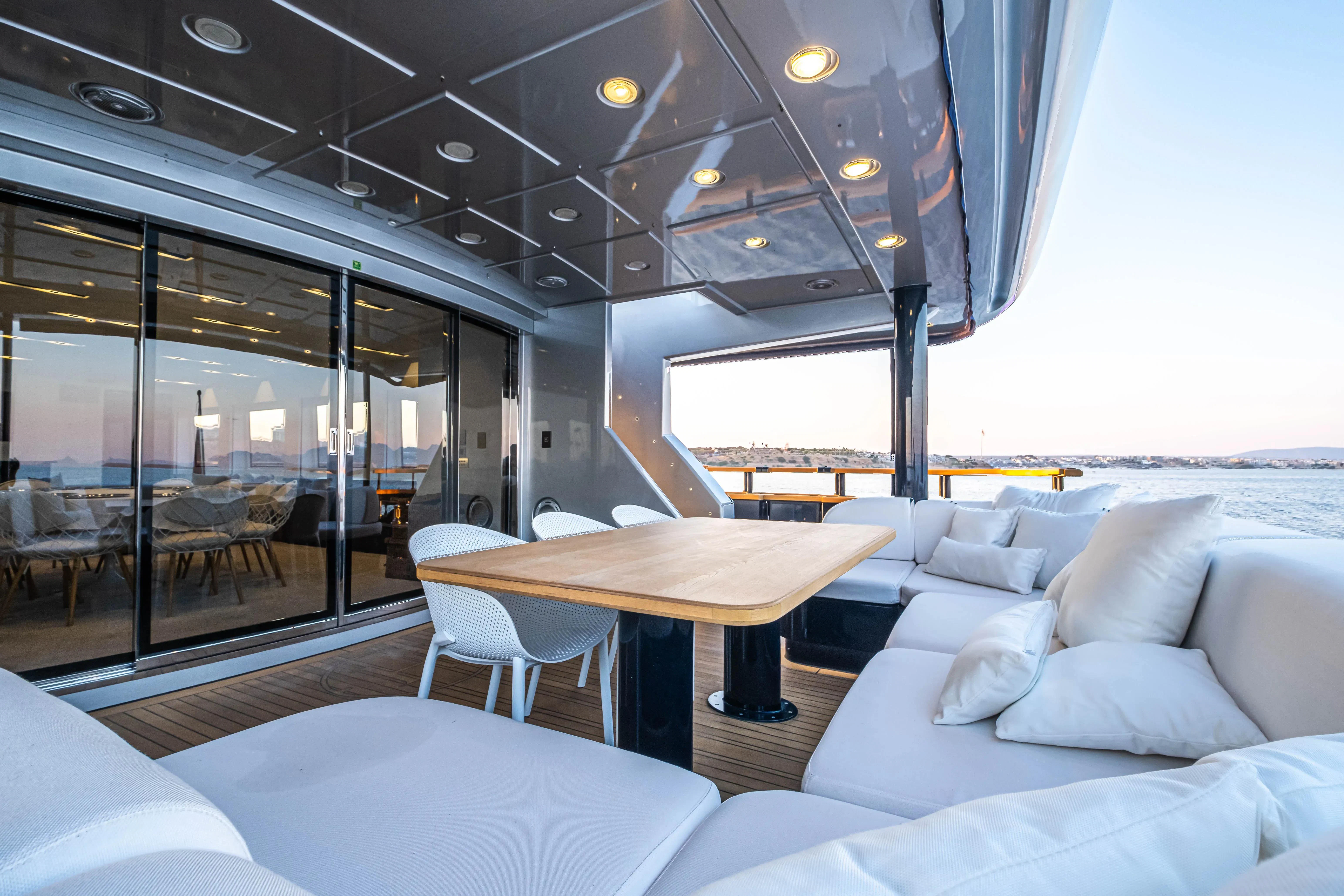 a room with a table and couches aboard HARUN Yacht for Charter