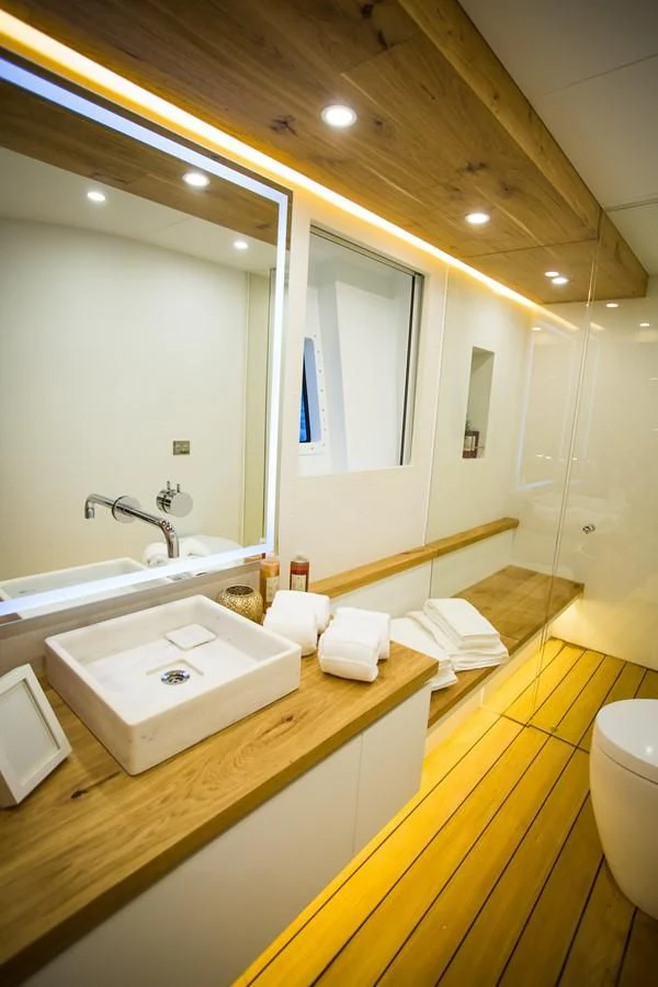 a bathroom with a large mirror aboard HARUN Yacht for Charter