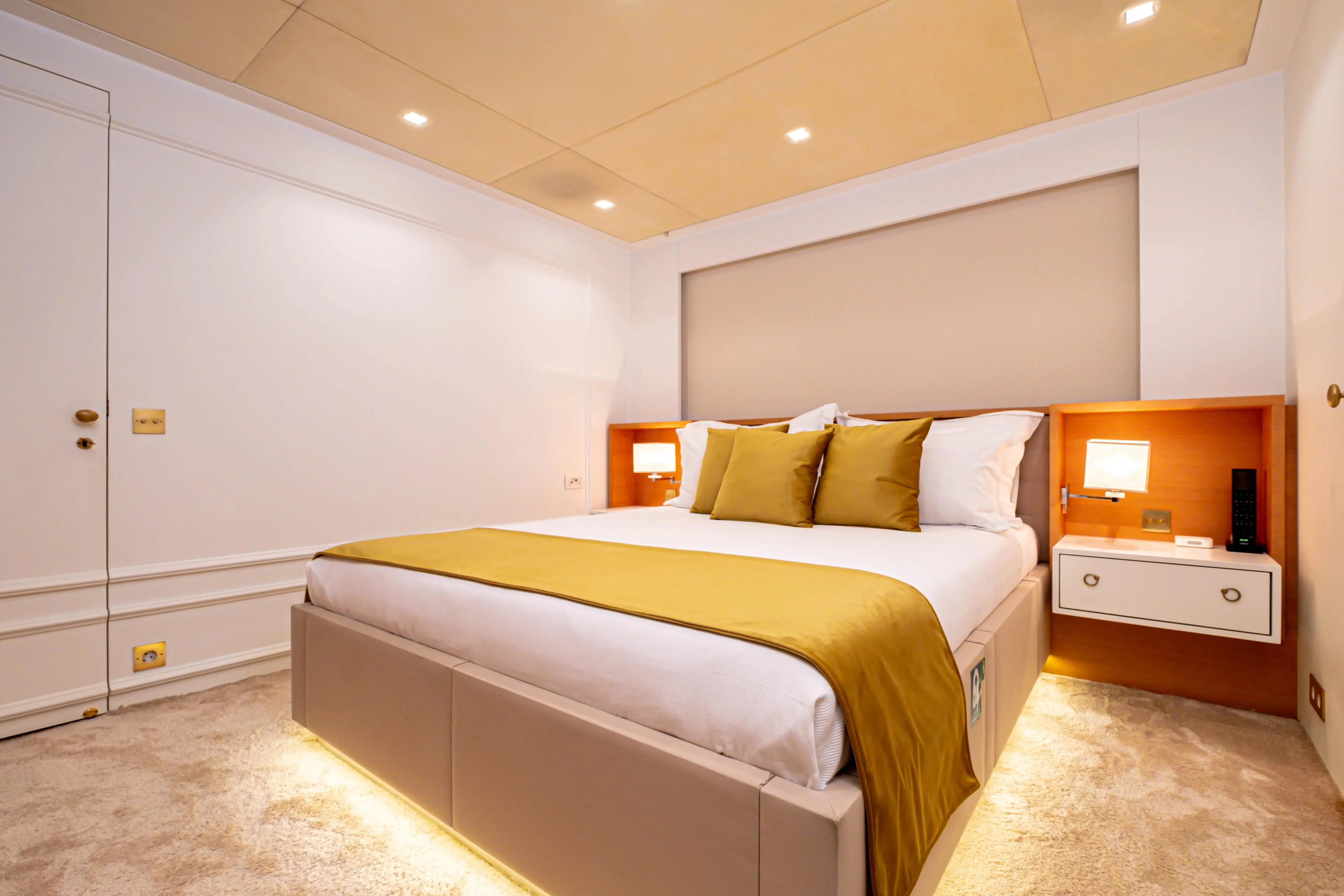 a bedroom with a bed and a desk aboard HARUN Yacht for Charter