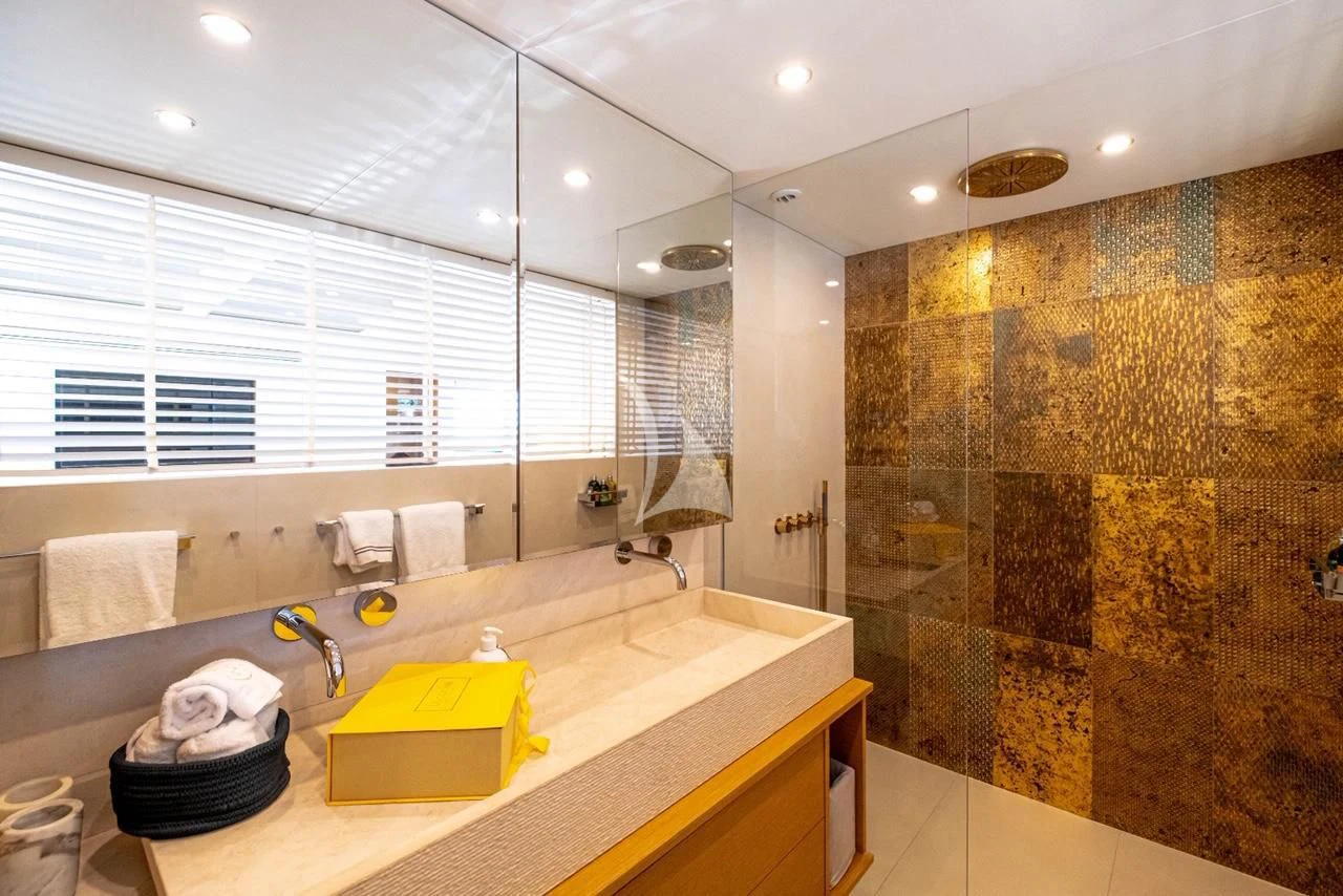 a bathroom with a countertop sink and a large mirror aboard HARUN Yacht for Charter