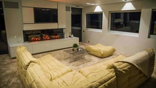 a living room with a fireplace aboard HARUN Yacht for Charter