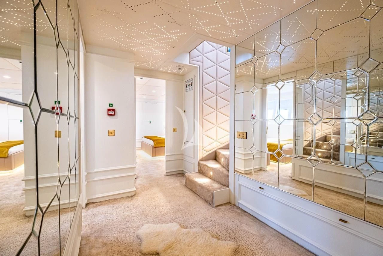 a room with a couch and a staircase aboard HARUN Yacht for Charter