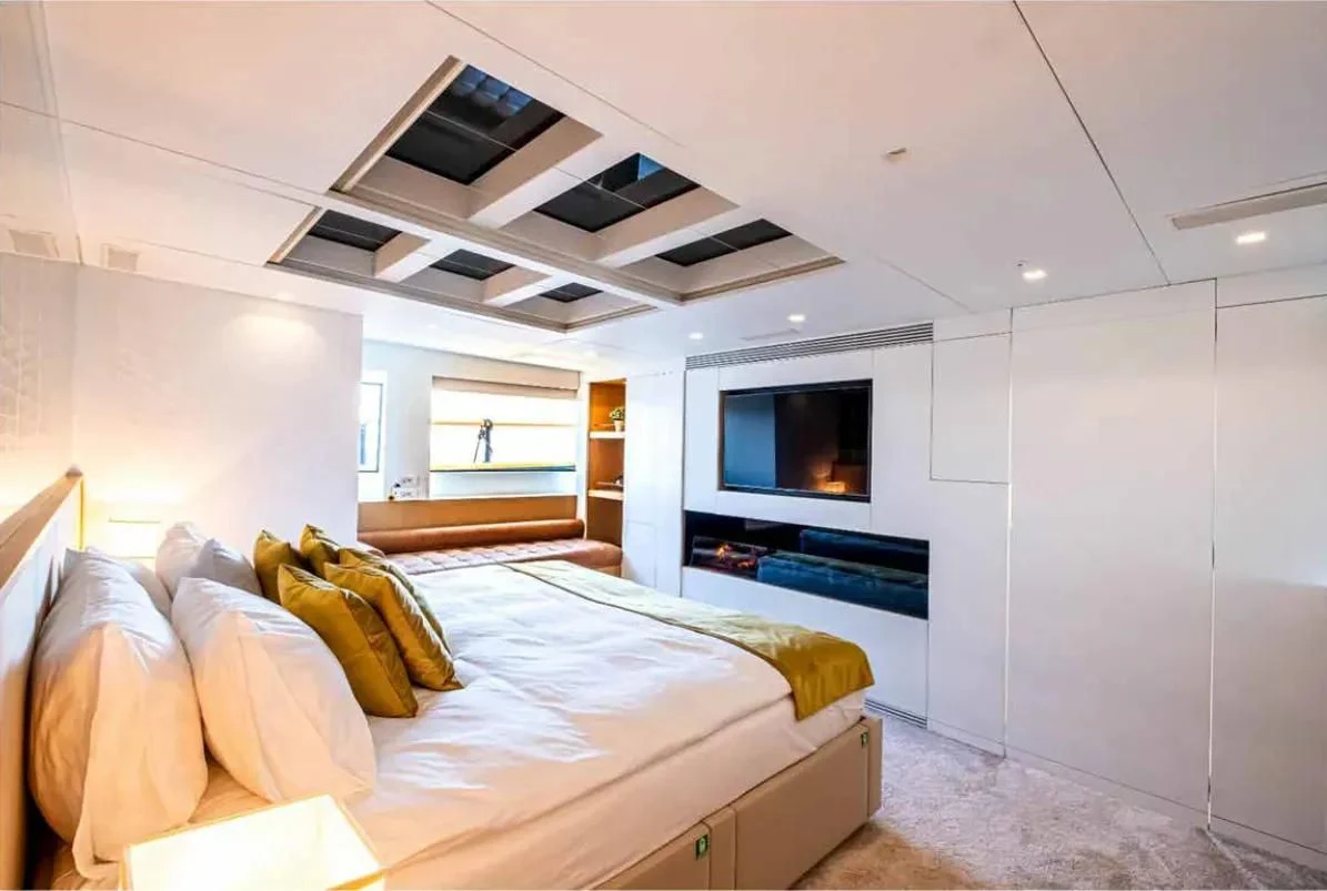 a bedroom with a bed and a tv aboard HARUN Yacht for Charter