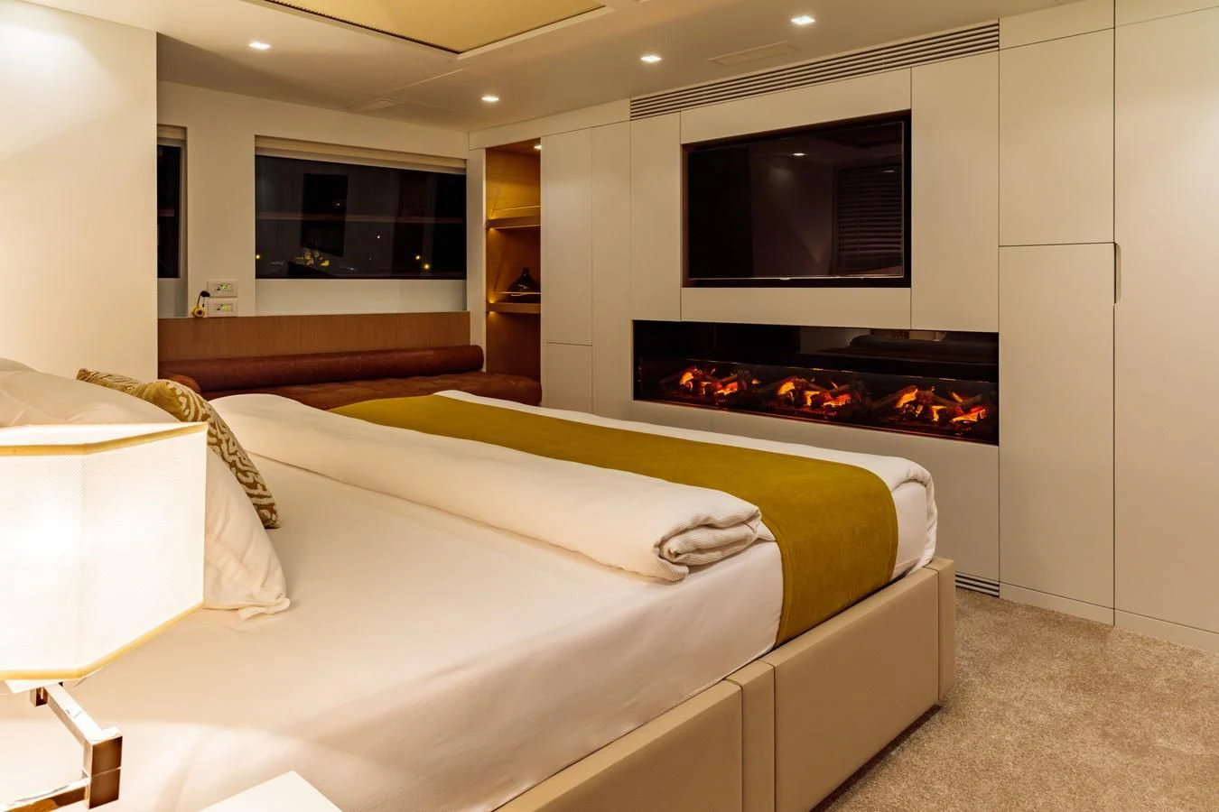 a bedroom with a fireplace aboard HARUN Yacht for Charter