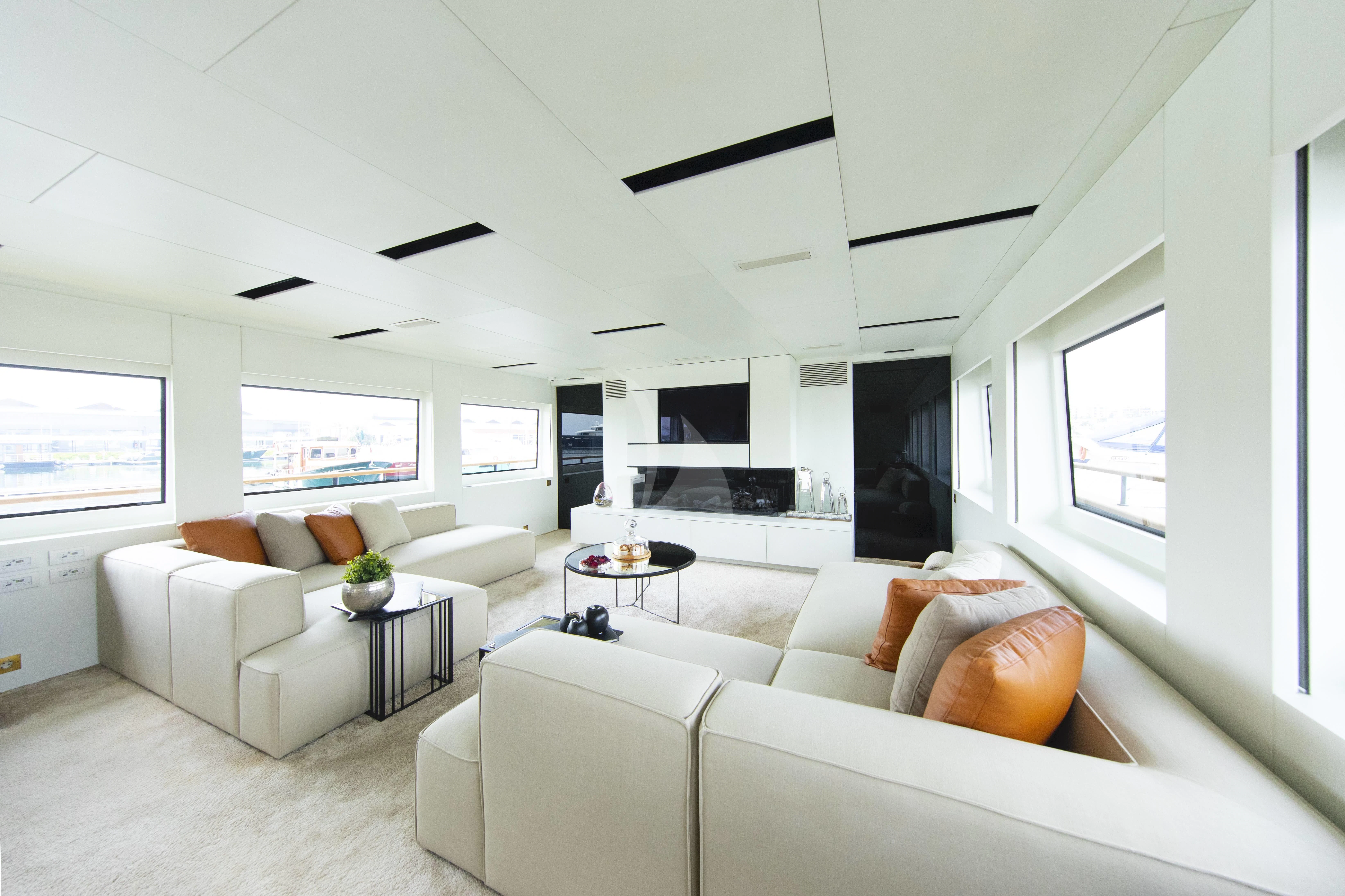 a living room with white furniture aboard HARUN Yacht for Charter