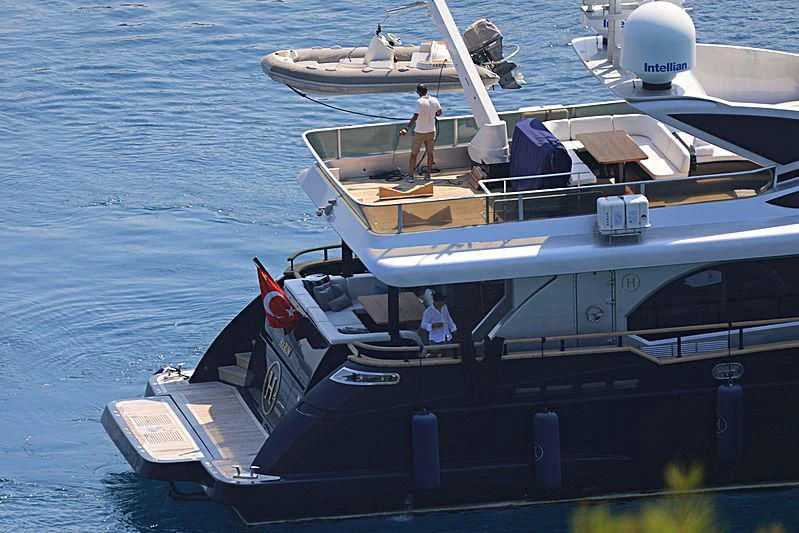 a boat with a person standing on it aboard HARUN Yacht for Charter