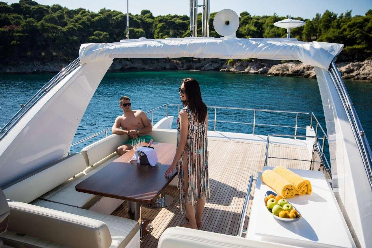 a man and woman sitting on a boat on the water aboard TAMARA II Yacht for Sale