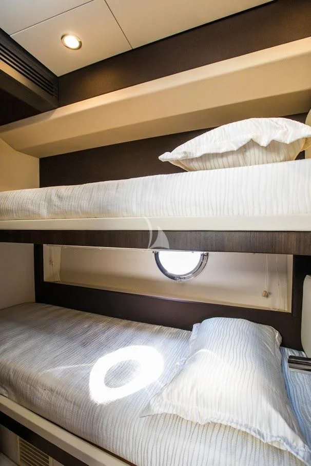 a bed with a white cover aboard TAMARA II Yacht for Sale