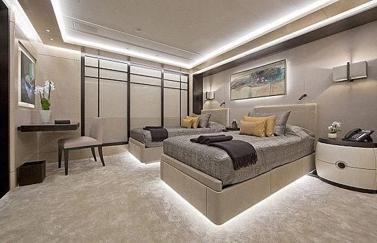a large bedroom with a large bed aboard MOGAMBO Yacht for Sale