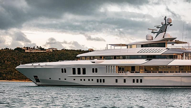 a large white boat with a helicopter on top of it aboard MOGAMBO Yacht for Sale