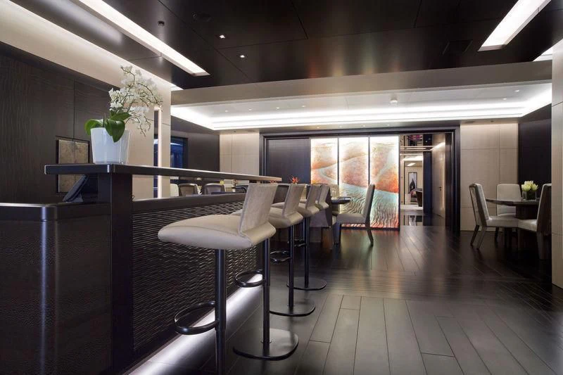 a room with tables and chairs aboard MOGAMBO Yacht for Sale