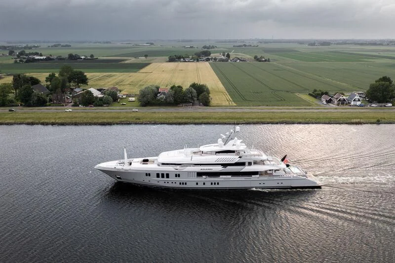 a white boat on a river aboard MOGAMBO Yacht for Sale