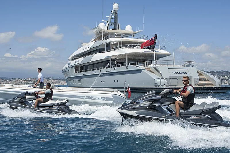 a boat with a couple of people on it aboard MOGAMBO Yacht for Sale