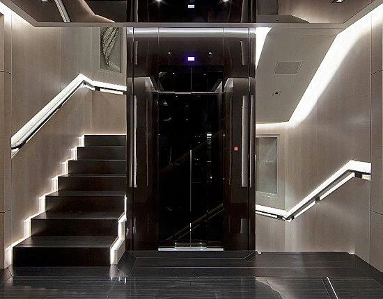 a dark elevator with a staircase aboard MOGAMBO Yacht for Sale