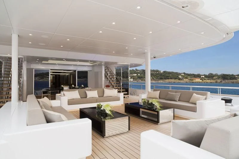 a living room with white couches and a pool aboard MOGAMBO Yacht for Sale