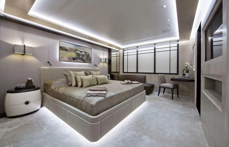 a large bedroom with a large bed aboard MOGAMBO Yacht for Sale