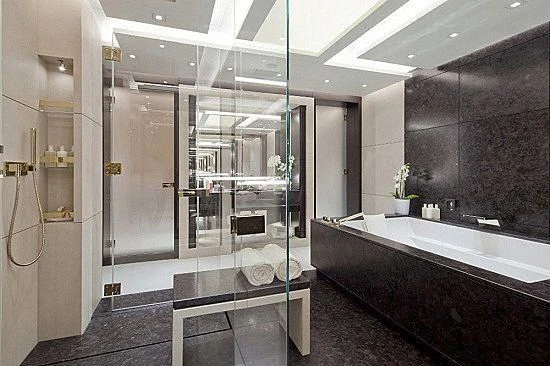 a bathroom with a tub and shower aboard MOGAMBO Yacht for Sale