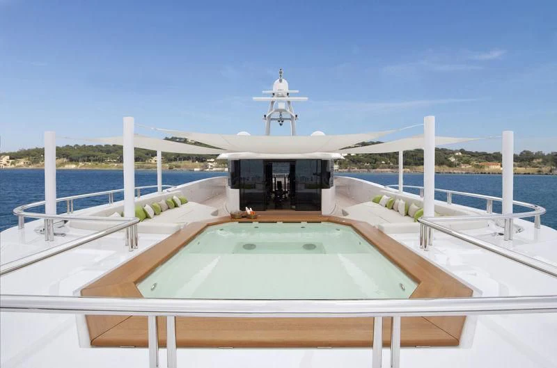 a deck with a pool and a water slide aboard MOGAMBO Yacht for Sale