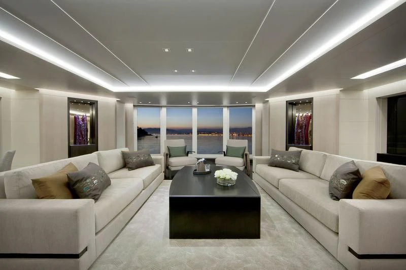a living room with a couch and a coffee table aboard MOGAMBO Yacht for Sale