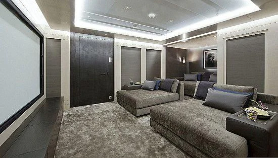 a room with a couch and a coffee table aboard MOGAMBO Yacht for Sale