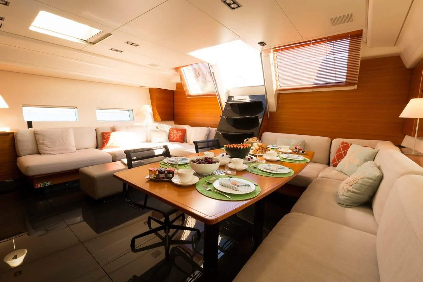 a living room with a table and couches aboard WALLY LOVE Yacht for Charter
