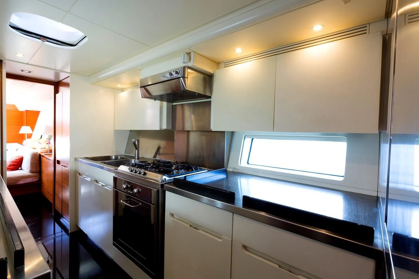 a kitchen with a stove and a microwave aboard WALLY LOVE Yacht for Charter