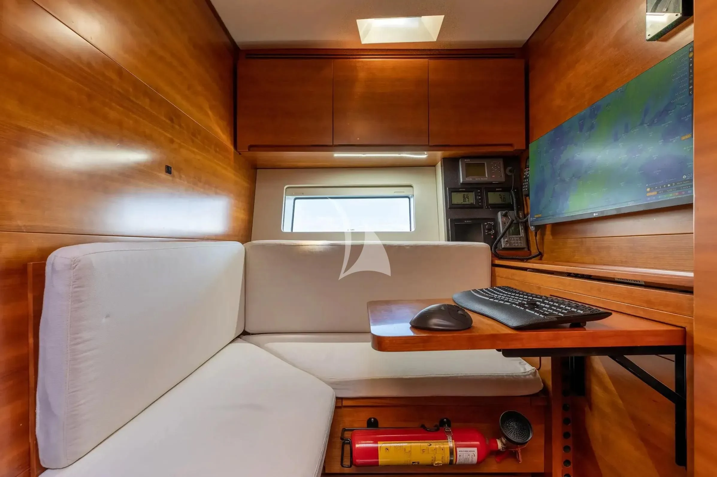 a room with a couch and a computer aboard WALLY LOVE Yacht for Charter