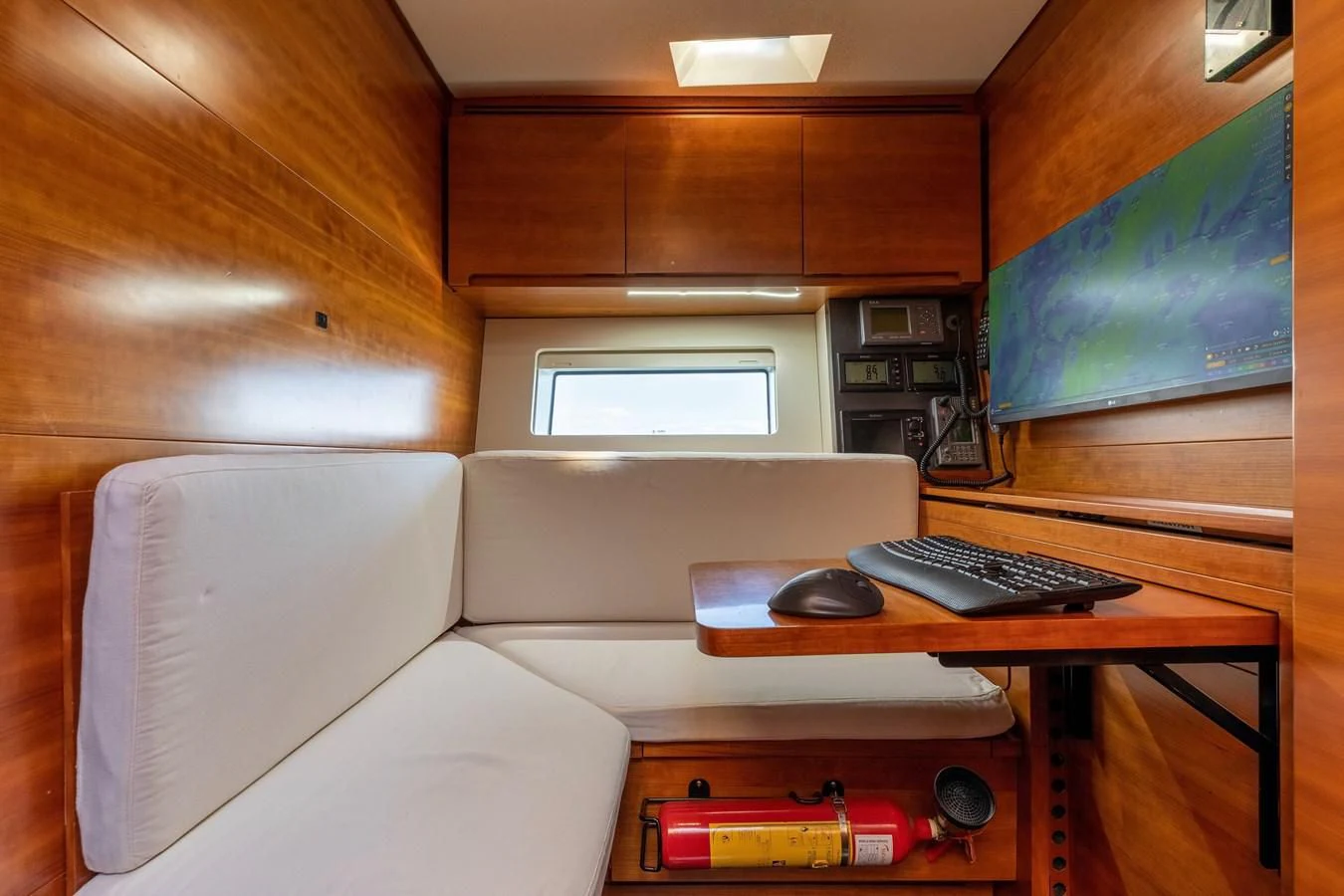 a room with a couch and a computer aboard WALLY LOVE Yacht for Charter