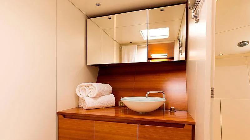 a bathroom with a sink and mirror aboard WALLY LOVE Yacht for Charter