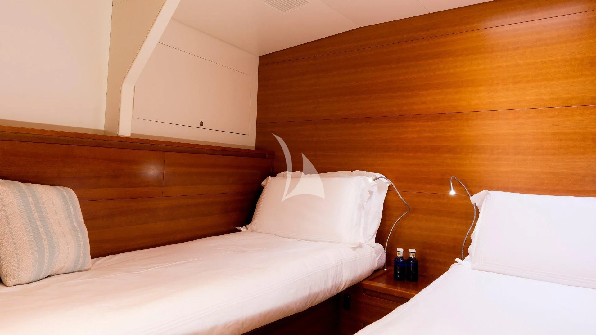 a bed with a white pillow and a wooden headboard aboard WALLY LOVE Yacht for Charter