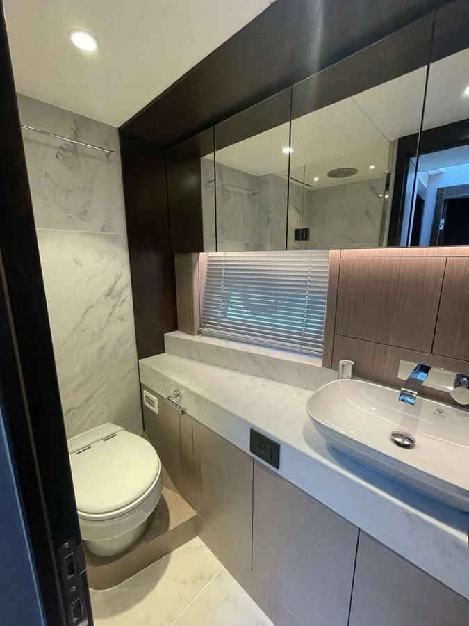 a bathroom with a sink and a toilet aboard SUNSEEKER 70' MANHATTAN Yacht for Sale
