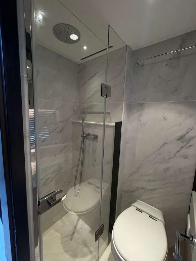 a bathroom with a glass shower aboard SUNSEEKER 70' MANHATTAN Yacht for Sale