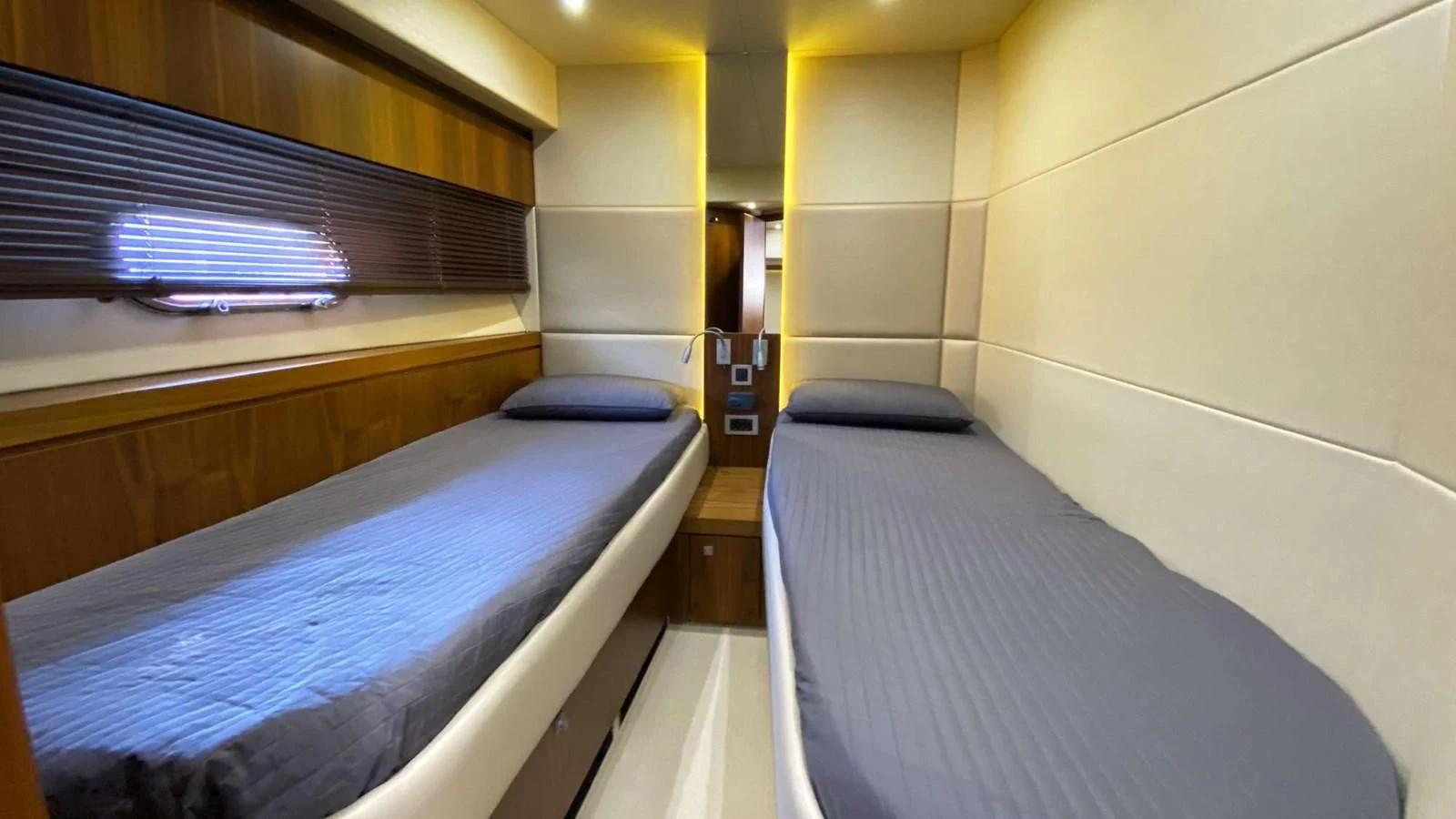 a room with beds and a window aboard SUNSEEKER 70' MANHATTAN Yacht for Sale