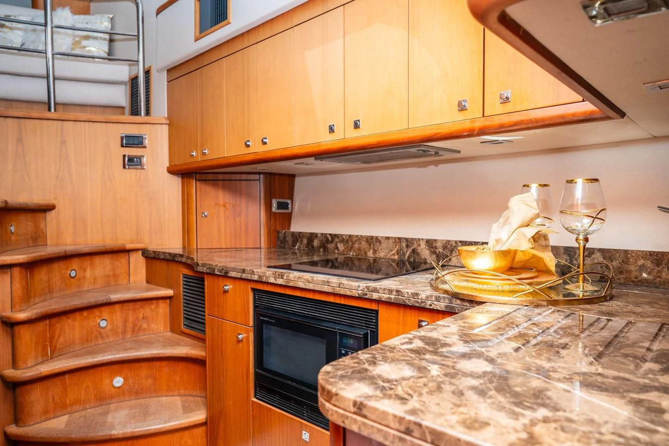 a kitchen with wooden cabinets aboard SUNSEEKER 70' MANHATTAN Yacht for Sale