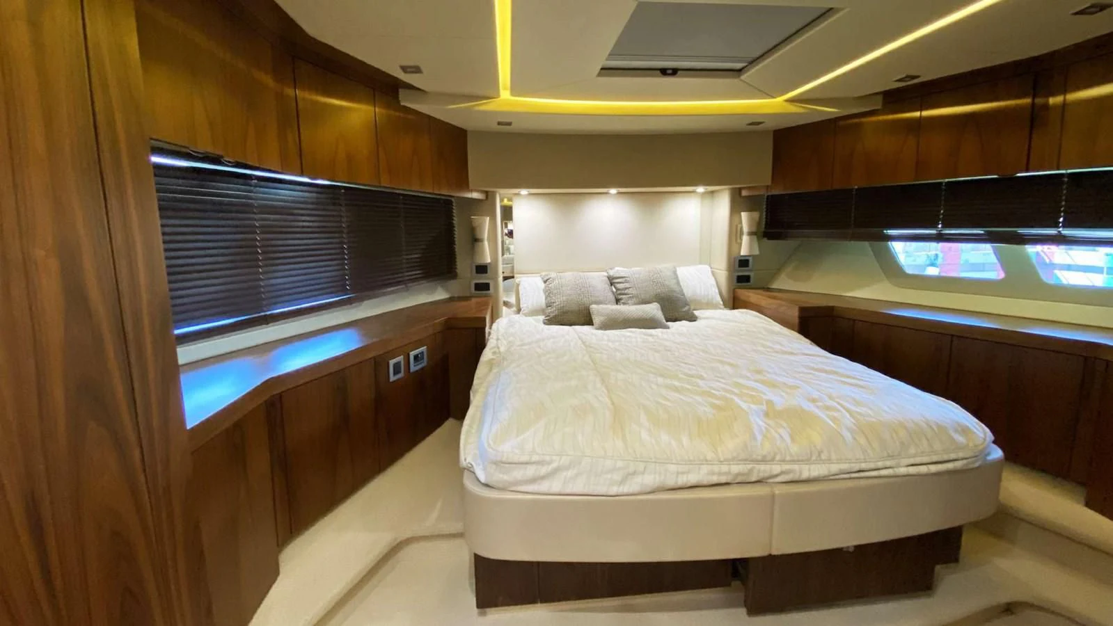 a room with a bed and a window aboard SUNSEEKER 70' MANHATTAN Yacht for Sale