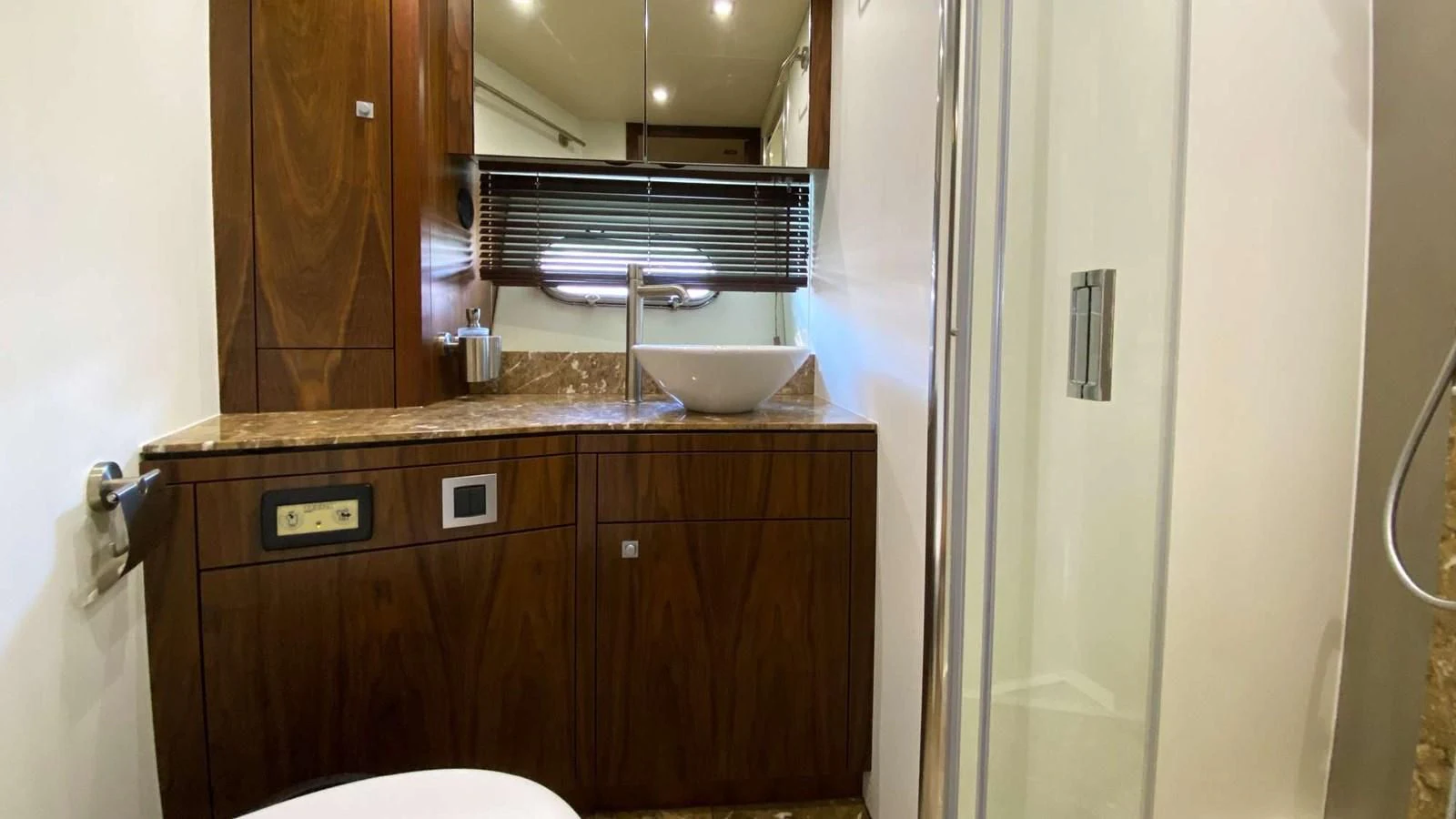 a bathroom with a sink and a mirror aboard SUNSEEKER 70' MANHATTAN Yacht for Sale