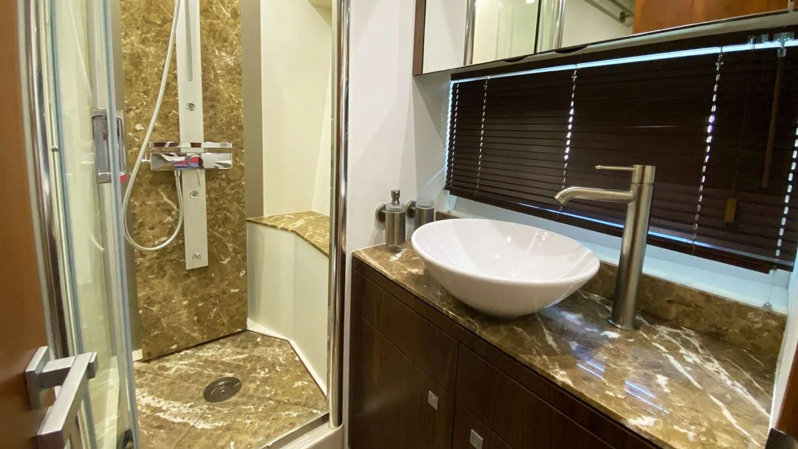 a bathroom with a sink and a large mirror aboard SUNSEEKER 70' MANHATTAN Yacht for Sale