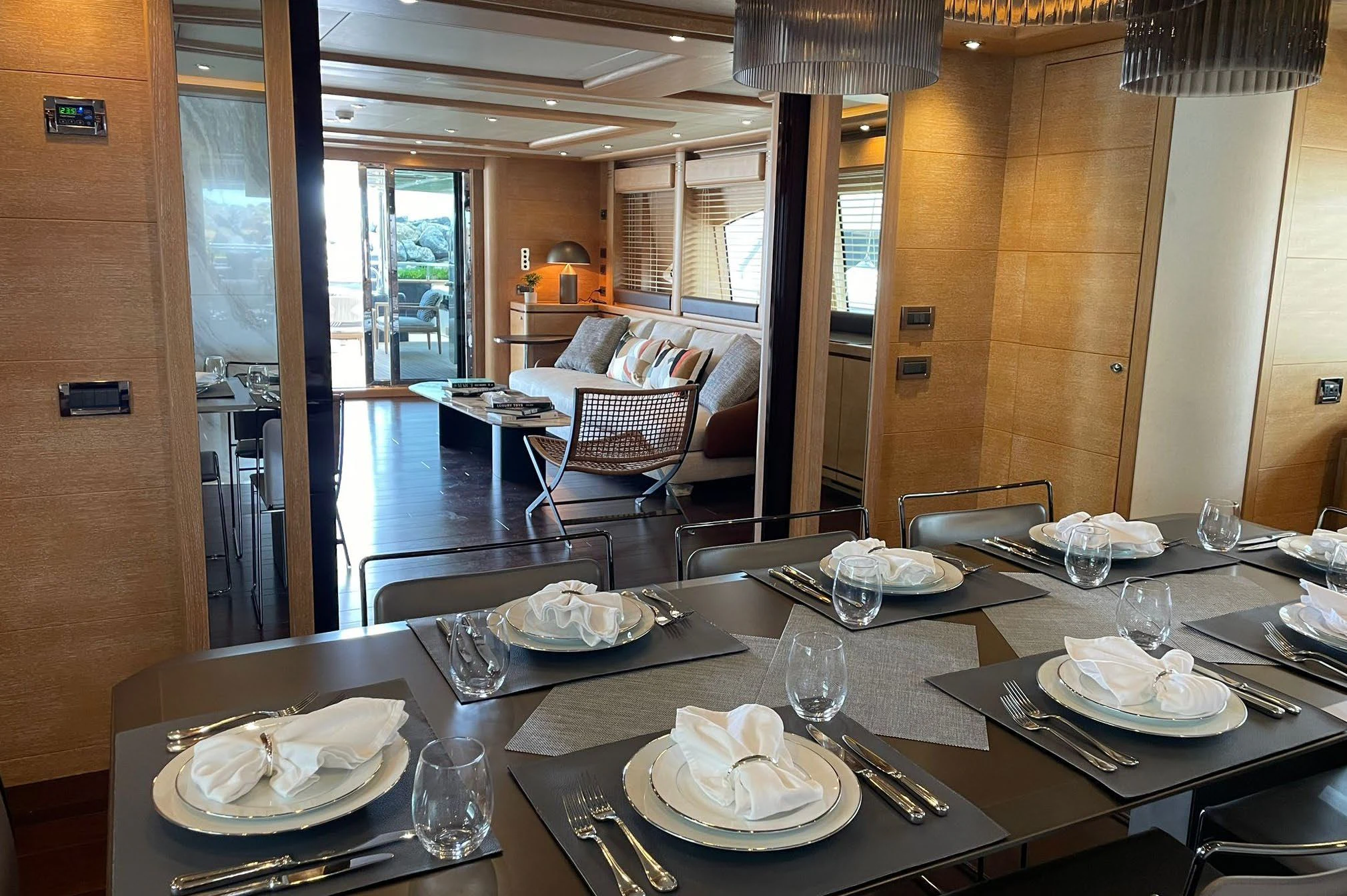 a table with plates and glasses aboard AERO Yacht for Charter