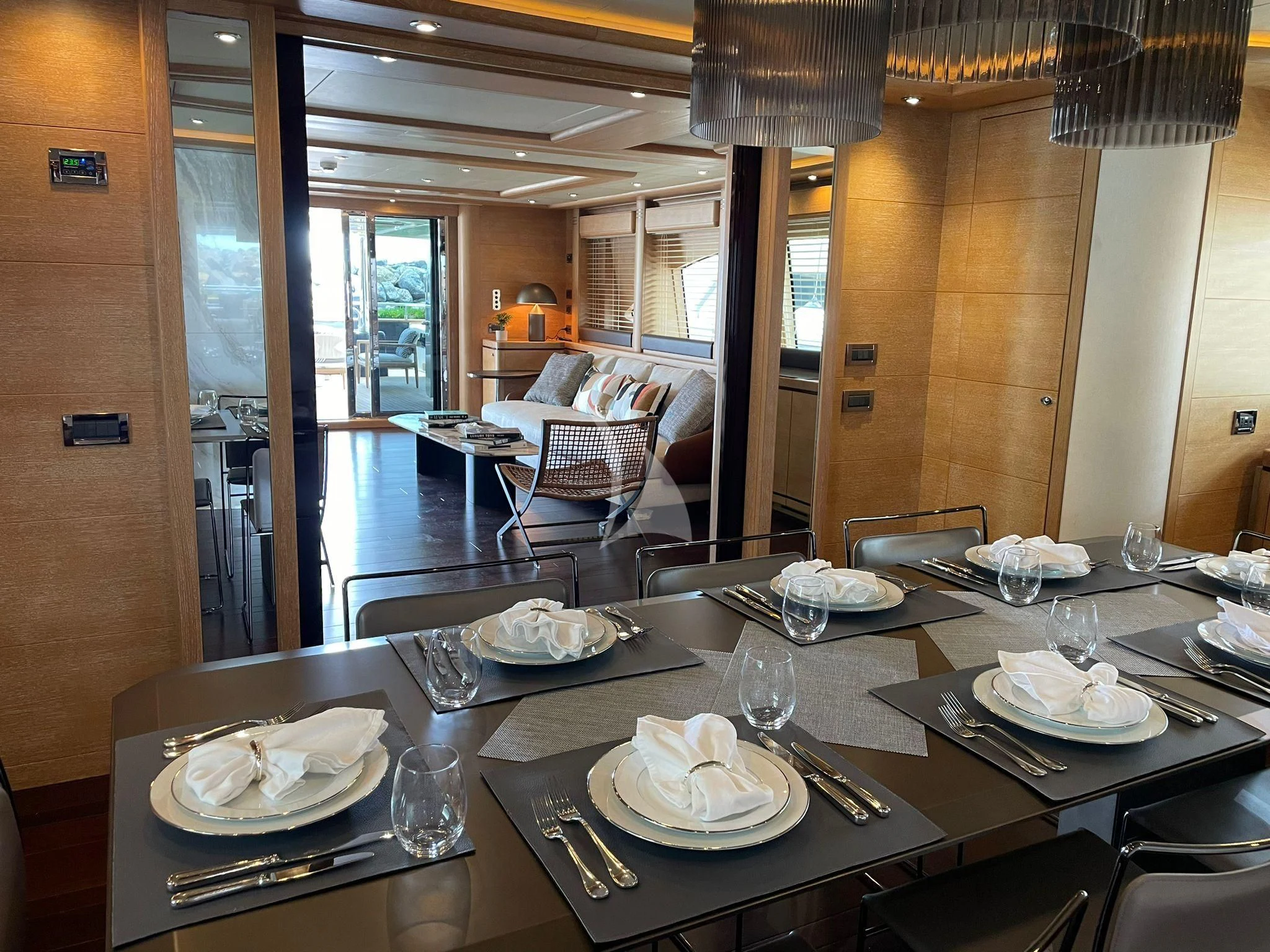 a table with plates and silverware aboard AERO Yacht for Charter