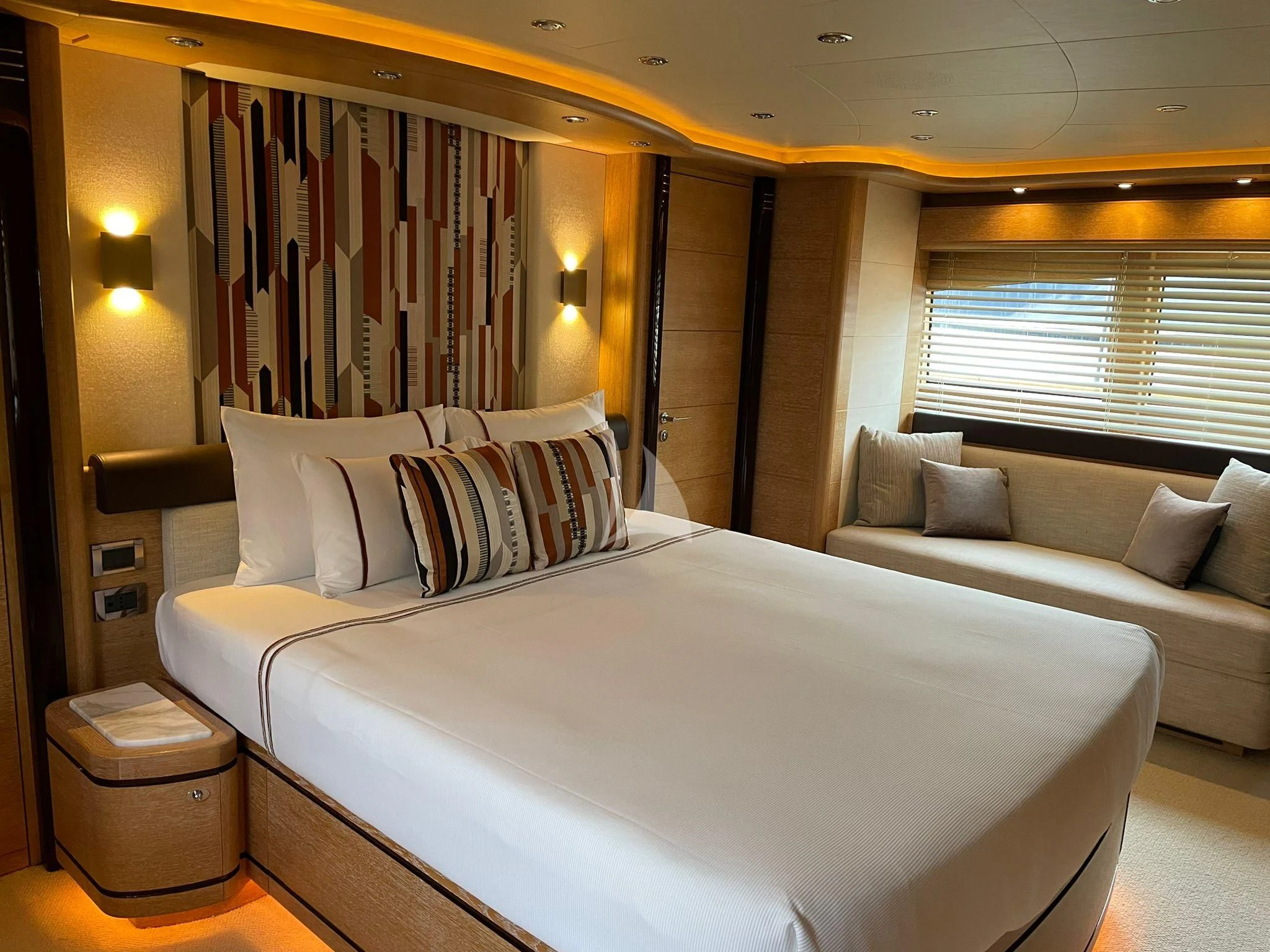 a bed with white sheets aboard AERO Yacht for Charter