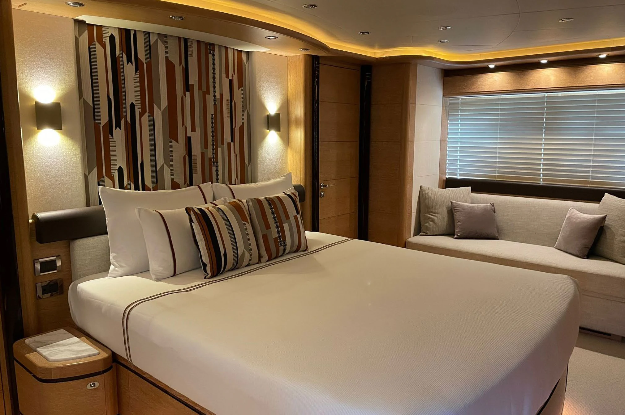 a bed with white sheets aboard AERO Yacht for Charter