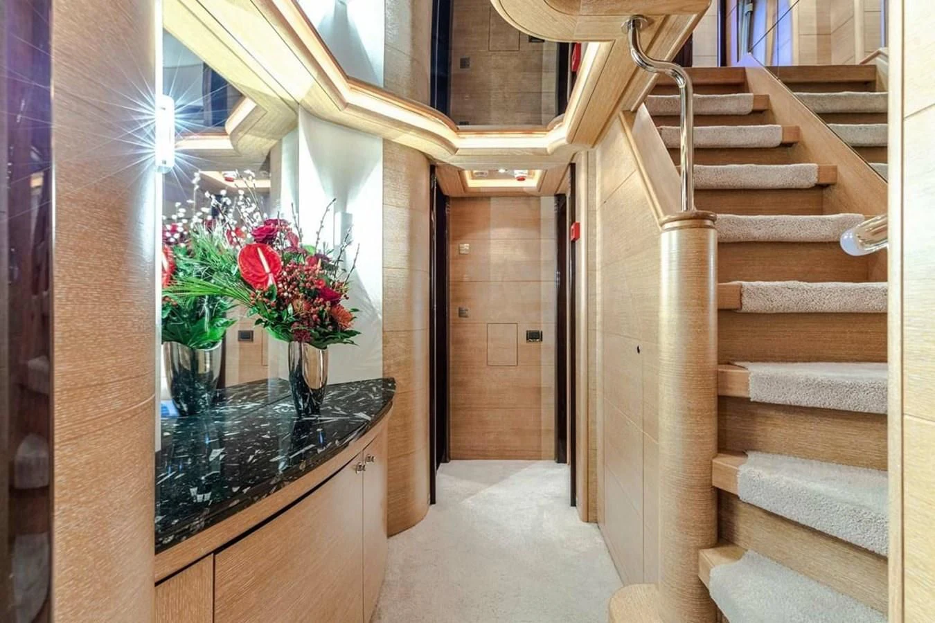 a staircase with a vase of flowers aboard AERO Yacht for Charter