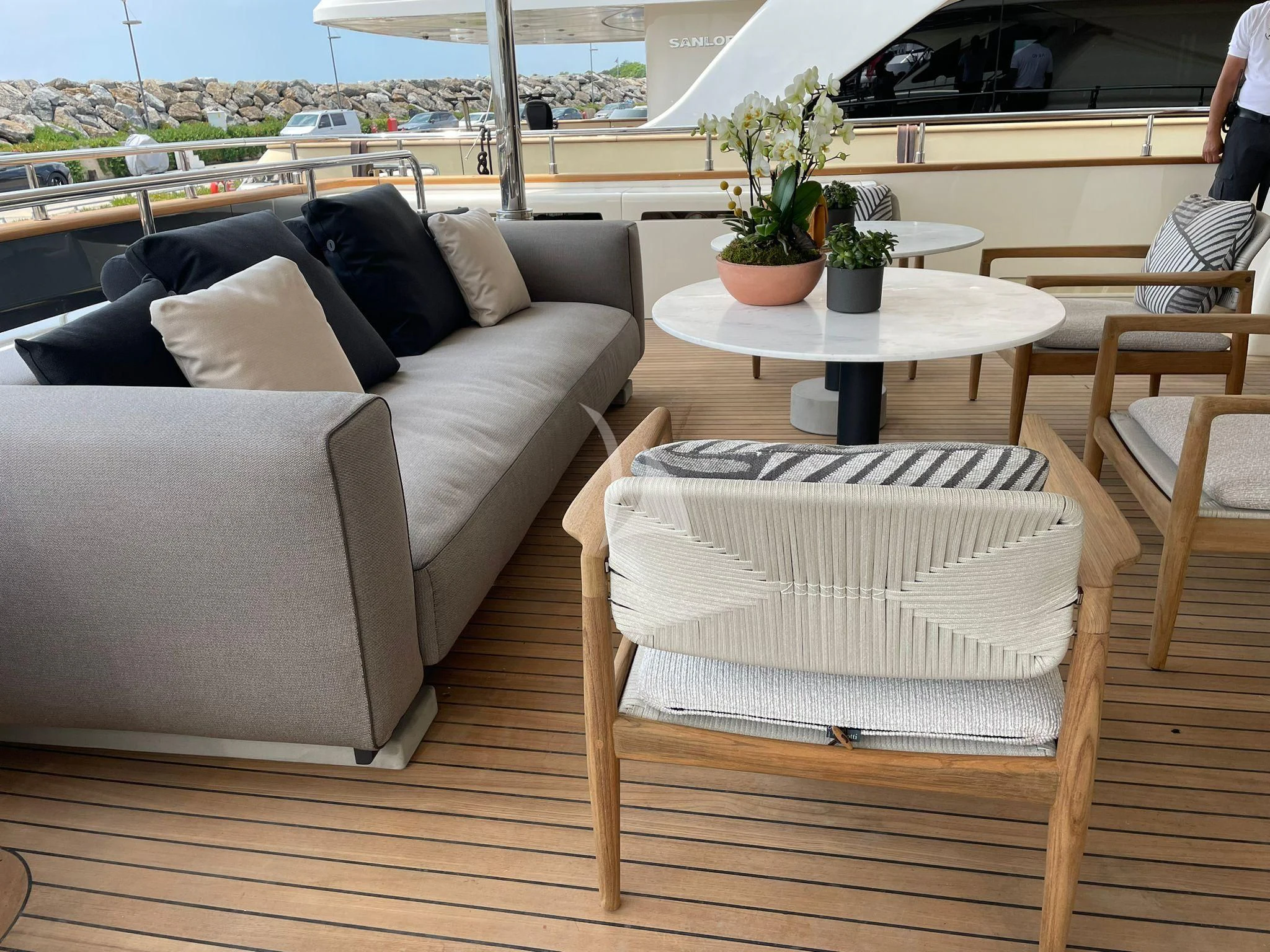 a couch and a table on a deck aboard AERO Yacht for Charter