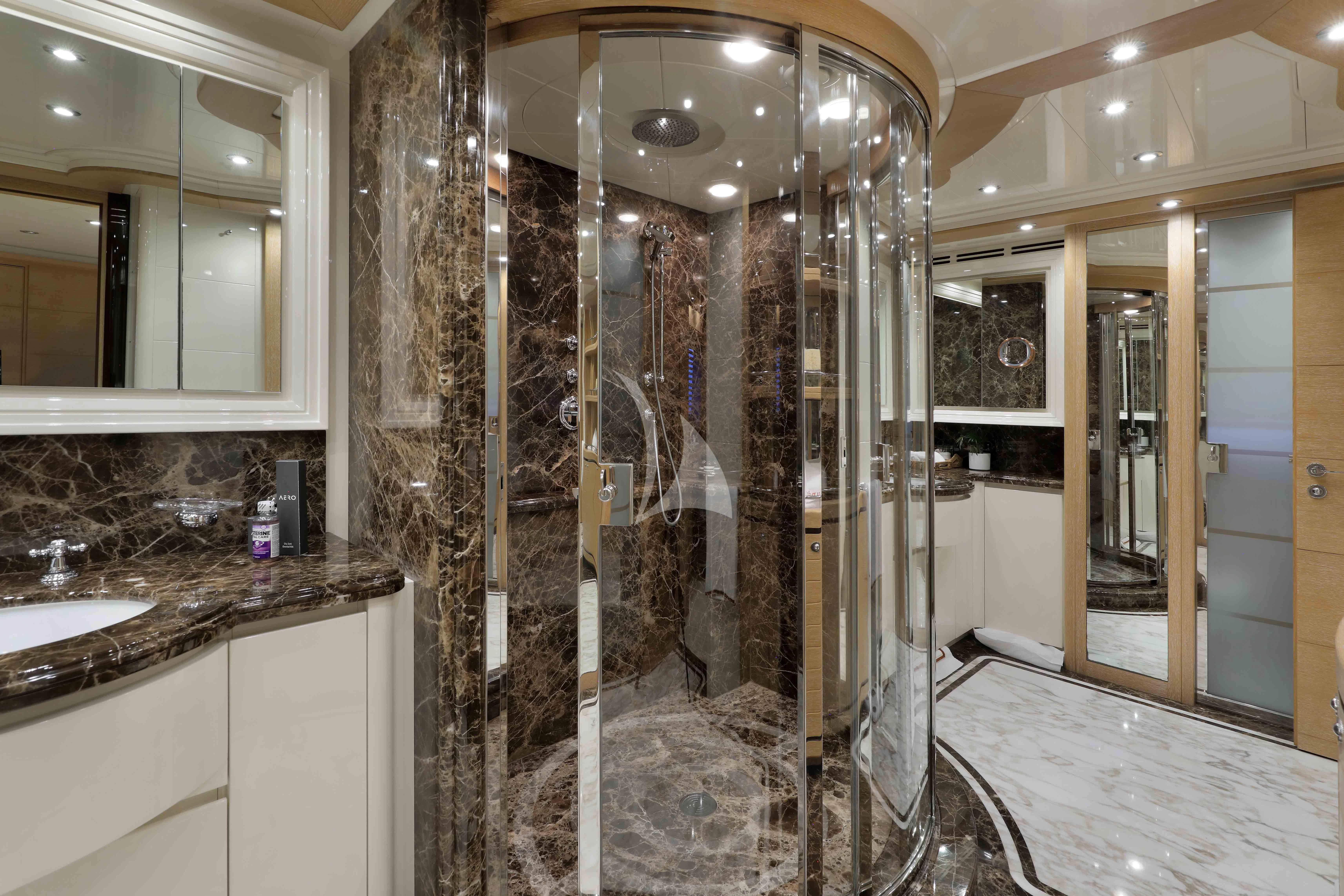 a bathroom with marble walls aboard AERO Yacht for Charter