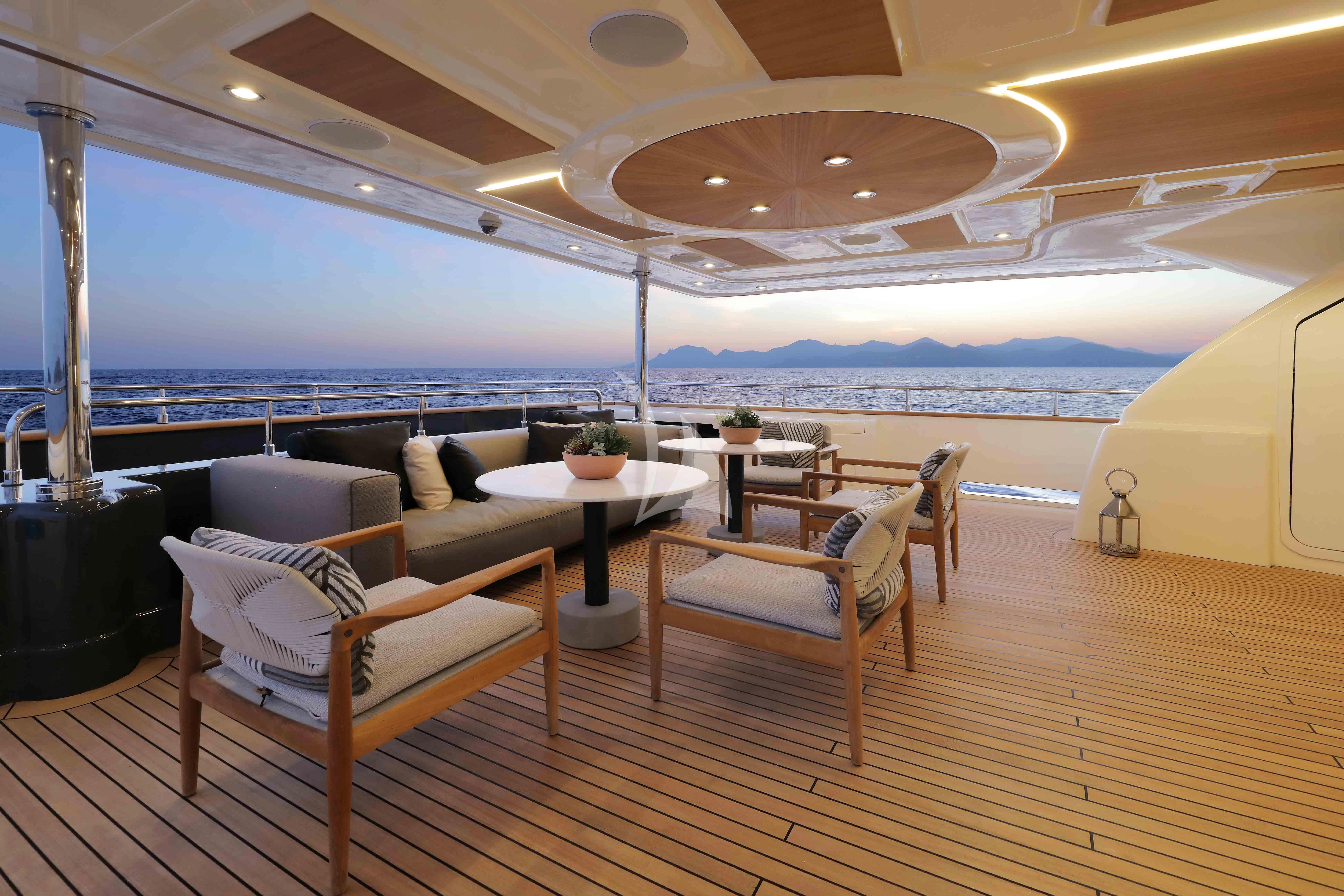 a room with a couch and a table and chairs aboard AERO Yacht for Charter