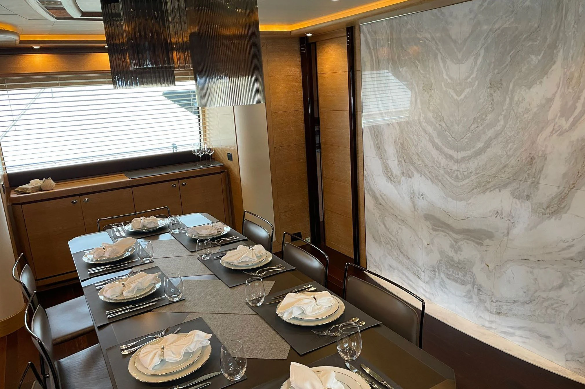 a dining table with plates and silverware aboard AERO Yacht for Charter