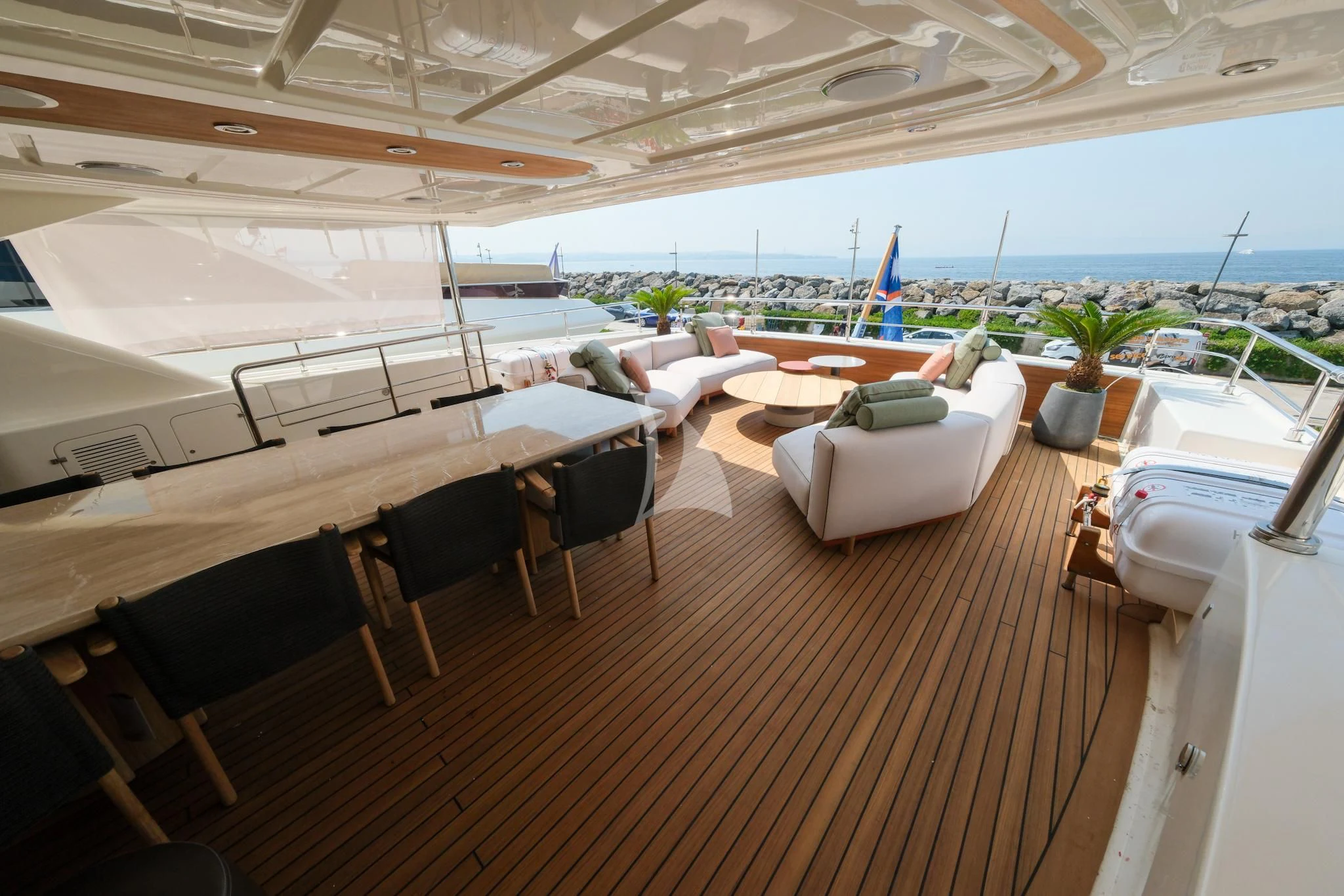 a room with a wood floor and a large window with a view of the ocean and a large aboard AERO Yacht for Charter