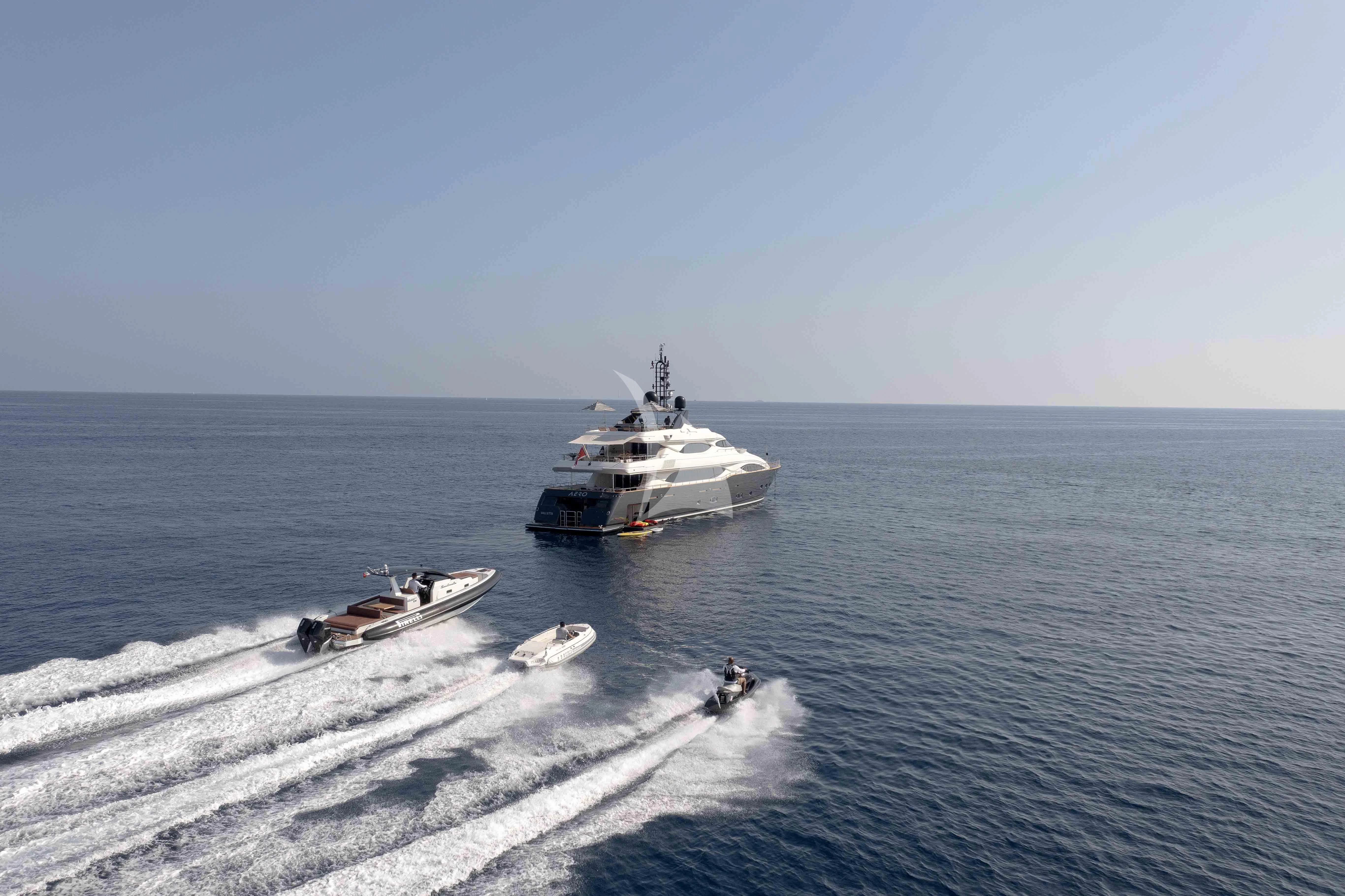 a couple of boats in the water aboard AERO Yacht for Charter